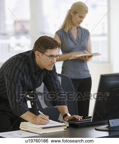 Businessman looking at computer View Large Photo Image Stock Photograph - Businessman looking at computer. Fotosearch
