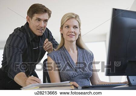 Businessman looking at computer View Large Photo Image Stock Photography - Businessman looking at computer. Fotosearch