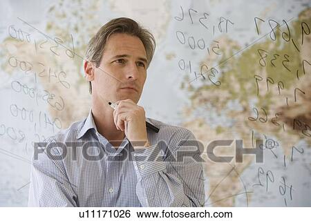 Businessman looking at dry erase board View Large Photo Image Stock Photograph - Businessman looking at dry erase board. Fotosearch