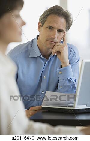 Businessman next to laptop View Large Photo Image Stock Image - Businessman next to laptop. Fotosearch