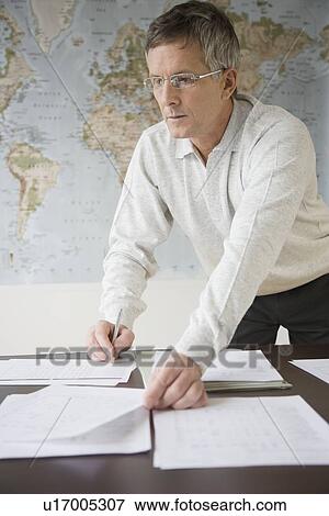 Stock Photo - Businessman organizing paperwork. Fotosearch