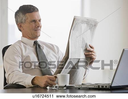 Businessman reading newspaper View Large Photo Image Stock Image - Businessman reading newspaper. Fotosearch