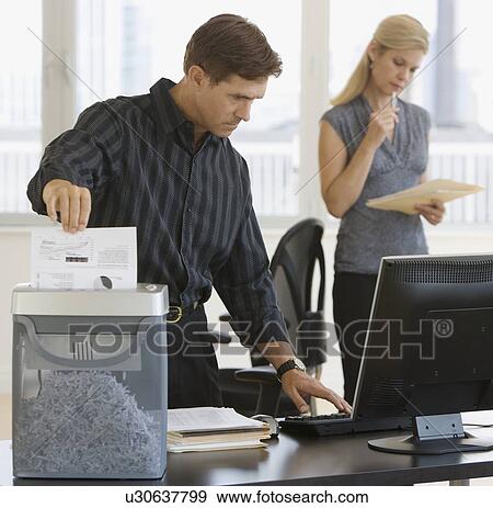 Stock Photo - Businessman shredding paperwork. Fotosearch