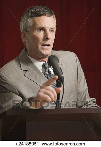 Businessman speaking at podium View Large Photo Image Stock Image - Businessman speaking at podium. Fotosearch