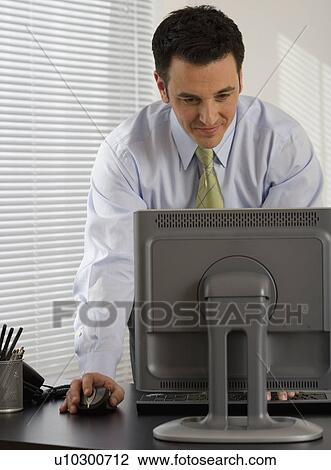 Stock Image - Businessman typing on computer. Fotosearch