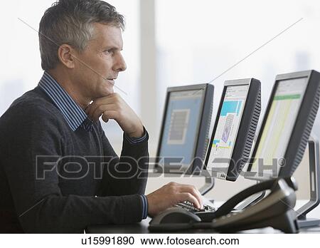 Stock Image - Businessman typing on computer. Fotosearch