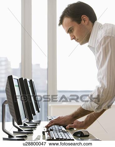 Businessman typing on computer View Large Photo Image Stock Photo - Businessman typing on computer. Fotosearch