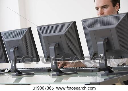 Stock Photography - Businessman typing on computer. Fotosearch