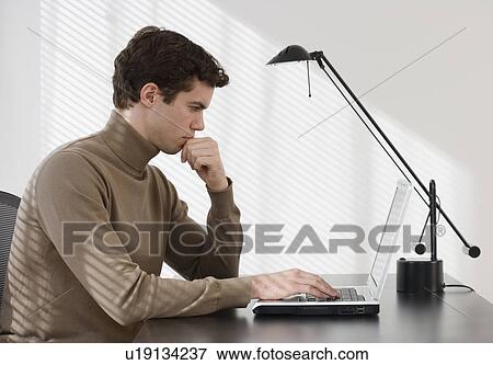 Businessman typing on laptop View Large Photo Image Stock Photo - Businessman typing on laptop. Fotosearch