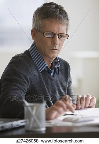 Businessman using calculator View Large Photo Image Stock Photo - Businessman using calculator. Fotosearch