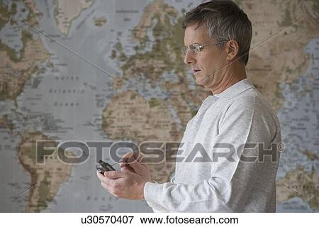 Stock Photo - Businessman using electronic organizer. Fotosearch