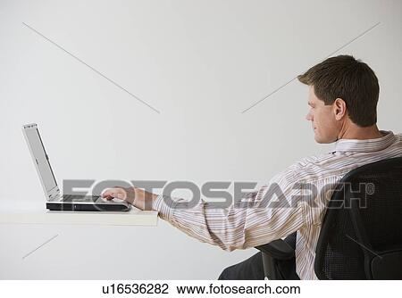 Stock Image - Businessman using laptop. Fotosearch