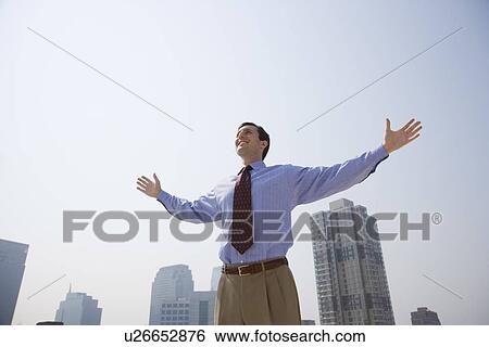 Stock Photograph - Businessman with arms outstretched. Fotosearch