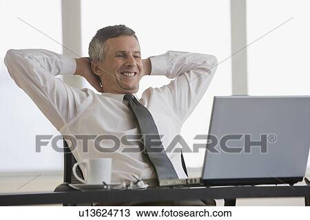 Businessman with hands behind head View Large Photo Image Stock Image - Businessman with hands behind head. Fotosearch