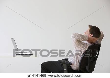 Stock Photo - Businessman with hands behind head. Fotosearch