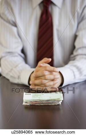 Stock Photography - Businessman with stack of Euro banknotes. Fotosearch