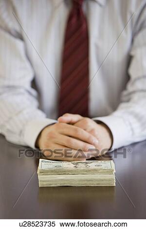 Businessman with stack of US Dollars View Large Photo Image Stock Photography - Businessman with stack of US Dollars. Fotosearch