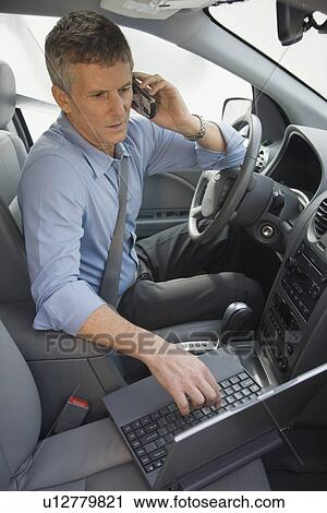 Businessman working in car View Large Photo Image Stock Image - Businessman working in car. Fotosearch