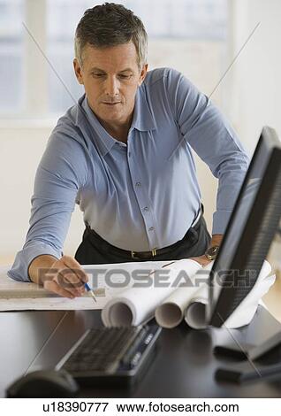 Businessman writing on blueprints View Large Photo Image Stock Photo - Businessman writing on blueprints. Fotosearch