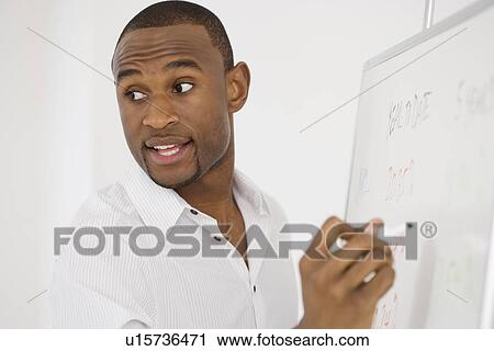 Businessman writing on whiteboard View Large Photo Image Stock Image - Businessman writing on whiteboard. Fotosearch