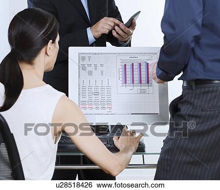 Businesspeople and around computer with graph on screen View Large Photo Image Stock Photograph - Businesspeople and around computer with graph on screen. Fotosearch