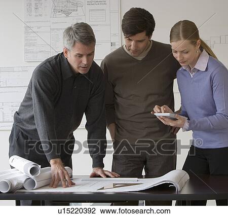 Stock Image - Businesspeople in architect’s office. Fotosearch
