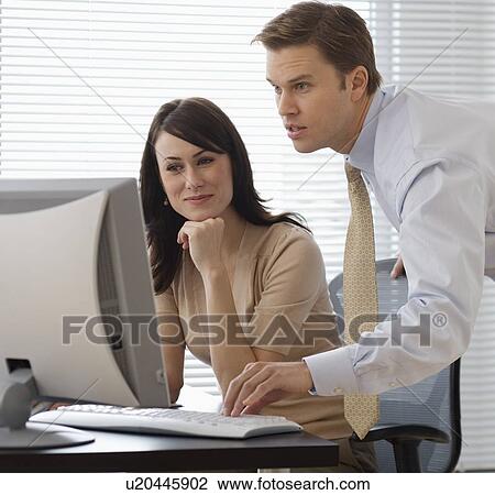 Businesspeople looking at computer View Large Photo Image Stock Image - Businesspeople looking at computer. Fotosearch