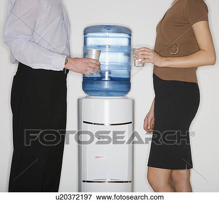 Businesspeople next to water cooler View Large Photo Image Stock Photo - Businesspeople next to water cooler. Fotosearch