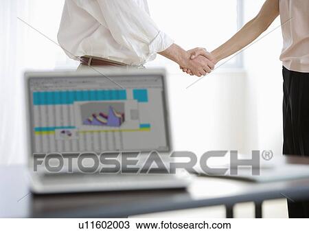 Stock Image - Businesspeople shaking hands. Fotosearch