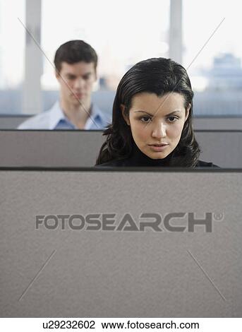 Stock Image - Businesspeople working in cubicles. Fotosearch