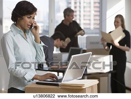 Businesspeople working in new office View Large Photo Image Stock Image - Businesspeople working in new office. Fotosearch