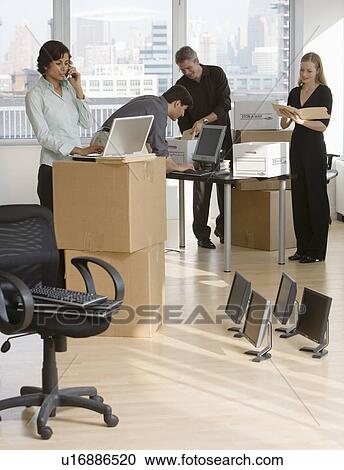 Businesspeople working in new office View Large Photo Image Stock Image - Businesspeople working in new office. Fotosearch
