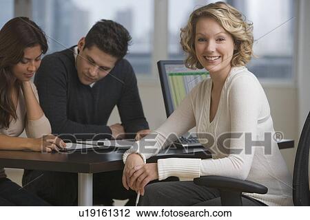 Businesswoman at desk with multi-ethnic couple View Large Photo Image Stock Image - Businesswoman at desk with multi-ethnic couple. Fotosearch