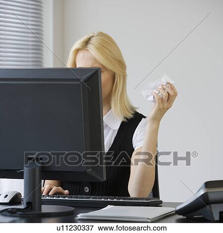 Businesswoman crumpling paper at desk View Large Photo Image Stock Photo - Businesswoman crumpling paper at desk. Fotosearch