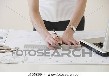 Businesswoman drawing on blueprints View Large Photo Image Picture - Businesswoman drawing on blueprints. Fotosearch