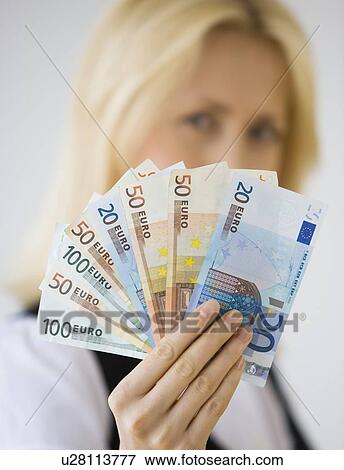 Businesswoman holding Euro banknotes View Large Photo Image Stock Photo - Businesswoman holding Euro banknotes. Fotosearch