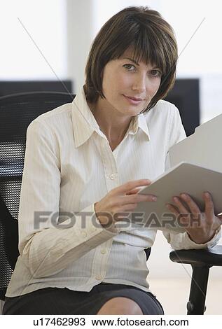 Businesswoman holding folder View Large Photo Image Stock Image - Businesswoman holding folder. Fotosearch