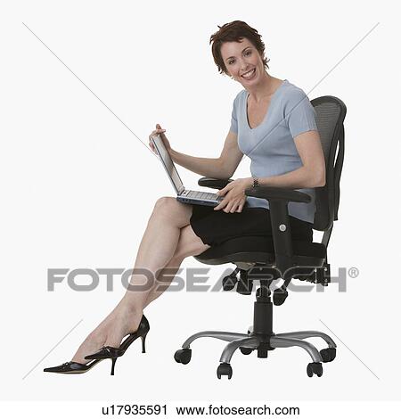 Businesswoman holding laptop View Large Photo Image Stock Image - Businesswoman holding laptop. Fotosearch
