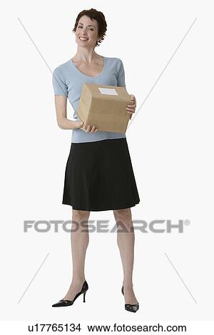 Picture - Businesswoman holding package. Fotosearch