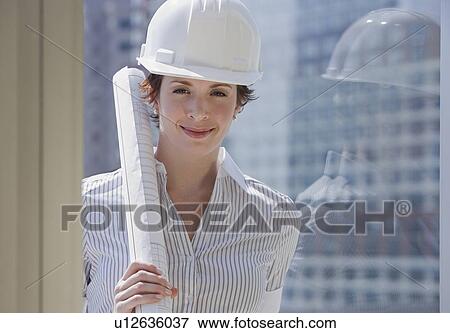 Businesswoman in hardhat holding blueprints View Large Photo Image Stock Photo - Businesswoman in hardhat holding blueprints. Fotosearch