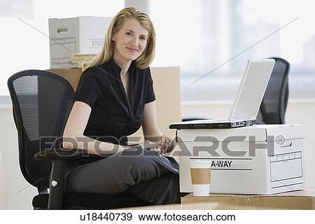 Stock Photo - Businesswoman in new office. Fotosearch