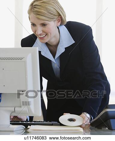 Businesswoman looking at computer View Large Photo Image Stock Image - Businesswoman looking at computer. Fotosearch