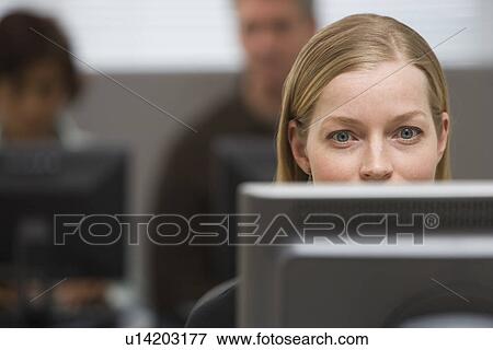 Businesswoman looking at computer View Large Photo Image Stock Photo - Businesswoman looking at computer. Fotosearch
