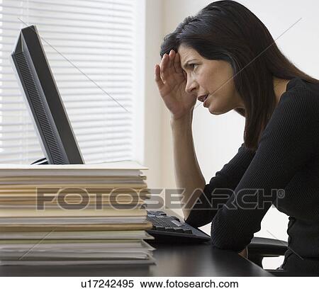 Businesswoman looking at computer View Large Photo Image Stock Photography - Businesswoman looking at computer. Fotosearch