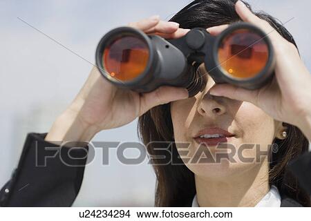 Businesswoman looking through binoculars View Large Photo Image Picture - Businesswoman looking through binoculars. Fotosearch