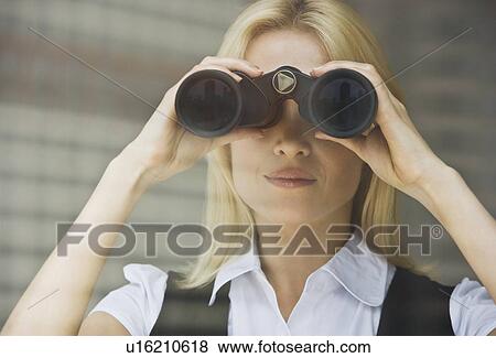 Businesswoman looking through binoculars View Large Photo Image Stock Photo - Businesswoman looking through binoculars. Fotosearch