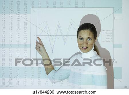 Businesswoman pointing at projected graph View Large Photo Image Stock Photograph - Businesswoman pointing at projected graph. Fotosearch