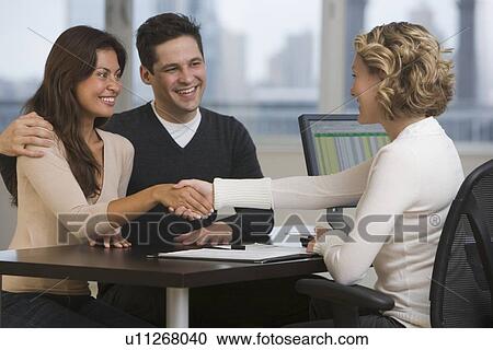 Businesswoman shaking hands with multi-ethnic couple View Large Photo Image Stock Image - Businesswoman shaking hands with multi-ethnic couple. Fotosearch