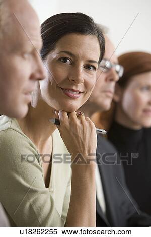 Stock Photography - Businesswoman smiling at meeting. Fotosearch