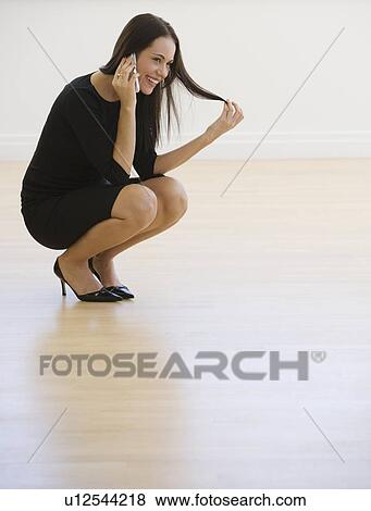 Businesswoman talking on cell phone View Large Photo Image Stock Photo - Businesswoman talking on cell phone. Fotosearch